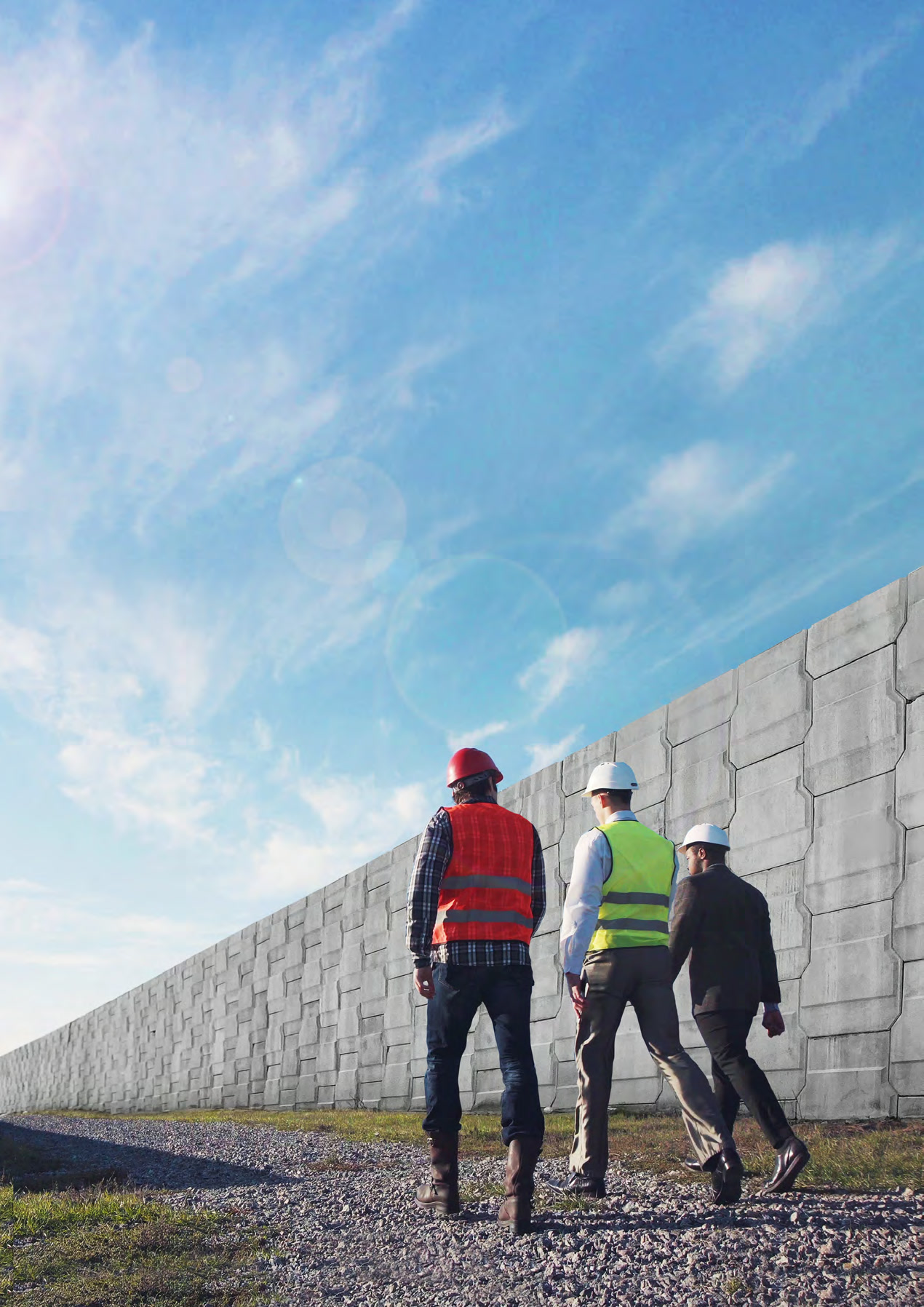 AnchorSOL engineers walking the length of a completed MSE retaining wall